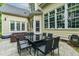 An outdoor patio features a black glass table, multiple chairs, and wicker furniture at 116 Hamilton Hedge Pl, Cary, NC 27519