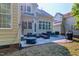 Backyard patio with a grill, various chairs and wicker furniture, and string lights above at 116 Hamilton Hedge Pl, Cary, NC 27519