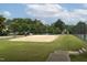 Sandy community volleyball court with net, surrounded by trees and greenery at 116 Hamilton Hedge Pl, Cary, NC 27519