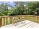 Back deck with garden chairs overlooking the yard, perfect for outdoor relaxation and privacy at 118 Setter Pt, Clayton, NC 27520