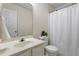 Bathroom features a sink with a mirror, toilet, and a shower with a white curtain at 118 Setter Pt, Clayton, NC 27520