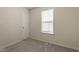 Bedroom features a window for natural light and closet space, perfect for a small sleeping area at 118 Setter Pt, Clayton, NC 27520