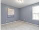 Cozy bedroom with gray walls, plush carpeting, and a window offering plenty of natural light at 118 Setter Pt, Clayton, NC 27520