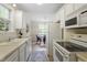 Open kitchen featuring white appliances, cabinets, and a view to the dining area at 118 Setter Pt, Clayton, NC 27520