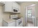 Practical kitchen featuring white appliances, cabinets, and neutral paint colors at 118 Setter Pt, Clayton, NC 27520
