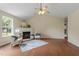 Bright living room featuring a fireplace, ceiling fan, hardwood floors, and two chairs at 118 Setter Pt, Clayton, NC 27520