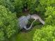 Overhead view of a home with verdant lawn and landscaping and a winding walkway at 1205 Elysian Way, Rougemont, NC 27572