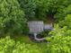 Bird's eye view of the home with manicured lawn and landscaping amidst dense trees at 1205 Elysian Way, Rougemont, NC 27572