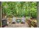 Relax on this wooden back deck featuring two chairs and views of the private backyard at 1205 Elysian Way, Rougemont, NC 27572