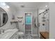 Bathroom featuring patterned tile floor, white vanity, and a walk-in shower with glass door at 1205 Elysian Way, Rougemont, NC 27572