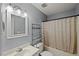 Bathroom featuring a sink and full bathtub with shelving for ample storage space at 1205 Elysian Way, Rougemont, NC 27572