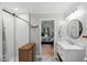 Updated bathroom featuring a stylish vanity, decorative tile floor, and a glass-enclosed shower at 1205 Elysian Way, Rougemont, NC 27572