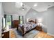 Bedroom with vaulted ceiling, a ceiling fan, natural light, and a bed with wood frame at 1205 Elysian Way, Rougemont, NC 27572