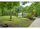 Expansive front yard with a long driveway leading to the home, surrounded by trees and landscaping at 1205 Elysian Way, Rougemont, NC 27572