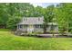 Charming home featuring dormer windows, black shutters and a well manicured lawn at 1205 Elysian Way, Rougemont, NC 27572