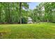 Large front yard with a well-maintained lawn and mature trees at 1205 Elysian Way, Rougemont, NC 27572