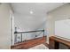 Upstairs hallway with hardwood floors, white railing and a view to the lower level at 1205 Elysian Way, Rougemont, NC 27572