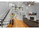 Open floor plan with high ceilings, hardwood floors, staircase, fireplace and view to kitchen at 1205 Elysian Way, Rougemont, NC 27572