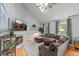 Bright living room boasting a fireplace, hardwood floors, a large sectional sofa, and a vaulted ceiling at 1205 Elysian Way, Rougemont, NC 27572
