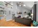 Open living room featuring hardwood floors, vaulted ceiling, fireplace, and a large sectional sofa at 1205 Elysian Way, Rougemont, NC 27572