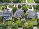 Aerial view of neighborhood featuring a lush landscaping, well-kept lawns, and a circular driveway at 1210 Brooks Ave, Raleigh, NC 27607