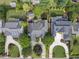 Aerial view of house with gray roof, well-manicured lawns, a circular driveway, and lush landscaping at 1210 Brooks Ave, Raleigh, NC 27607