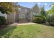 Brick home featuring a stone patio, well-kept lawn, and lush landscaping offers a serene outdoor living space at 1210 Brooks Ave, Raleigh, NC 27607