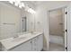 Bathroom featuring double sinks, granite counters, updated lighting, and a tub/shower combo at 1210 Brooks Ave, Raleigh, NC 27607