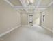 Bright bedroom features a tray ceiling with fan, carpet, and neutral wall color at 1210 Brooks Ave, Raleigh, NC 27607
