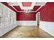 Dining room with hardwood floors, white trim, a red accent wall, and a chandelier at 1210 Brooks Ave, Raleigh, NC 27607