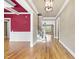 Open foyer with hardwood floors, white trim, high ceilings, and a glimpse of a staircase leading to the second floor at 1210 Brooks Ave, Raleigh, NC 27607