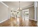 Spacious living room featuring hardwood floors, large windows, and entry to the kitchen, perfect for entertaining at 1210 Brooks Ave, Raleigh, NC 27607