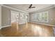 Open living area boasts hardwood floors, shuttered windows, and seamless flow to kitchen at 1210 Brooks Ave, Raleigh, NC 27607