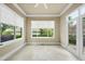 Cozy sun room with tile flooring, large windows with views, and entry to an outdoor space at 1210 Brooks Ave, Raleigh, NC 27607