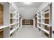 Large walk-in closet with white shelving and cedar plank walls for ample storage at 1210 Brooks Ave, Raleigh, NC 27607