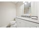 Bright bathroom with a white vanity, grey countertop and decorative mirror at 124 Twin Oaks Pl, Cary, NC 27511