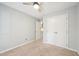 Bedroom featuring tan carpet, a ceiling fan and a double door closet at 124 Twin Oaks Pl, Cary, NC 27511