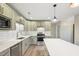 Modern kitchen with stainless steel appliances, island, granite countertops, and stylish cabinets at 124 Twin Oaks Pl, Cary, NC 27511