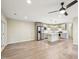 Open-concept kitchen and living space with stainless appliances, kitchen island, and modern finishes at 124 Twin Oaks Pl, Cary, NC 27511