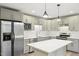 Modern kitchen with stainless steel appliances and updated cabinetry at 124 Twin Oaks Pl, Cary, NC 27511