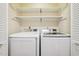 Neat laundry area with washer, dryer and storage shelves at 124 Twin Oaks Pl, Cary, NC 27511