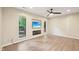 Bright living room with wood floors, ceiling fan, and built-in fireplace with flatscreen TV at 124 Twin Oaks Pl, Cary, NC 27511