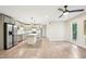 Open-concept kitchen and living area with stainless appliances, new floors and fixtures, and natural light at 124 Twin Oaks Pl, Cary, NC 27511