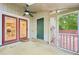 Covered patio with ceiling fan, red framed doors, and access to the kitchen at 124 Twin Oaks Pl, Cary, NC 27511