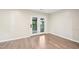 Neutral toned room featuring hard wood flooring and French doors leading to outdoor area at 124 Twin Oaks Pl, Cary, NC 27511