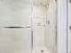 Bright, clean shower featuring white tile, a frosted glass door, and modern fixtures at 124 Twin Oaks Pl, Cary, NC 27511