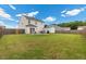 Expansive backyard featuring a patio, seating area, grill, shed and green grass at 13 Toplanders Ter, Gibsonville, NC 27249