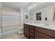 Bright bathroom featuring a double vanity, framed mirror, separate shower, and walk-in closet access at 13 Toplanders Ter, Gibsonville, NC 27249