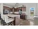 Modern kitchen featuring dark cabinetry, granite countertops, stainless steel appliances, and outside access at 13 Toplanders Ter, Gibsonville, NC 27249