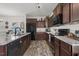 Well-equipped kitchen features granite countertops and brown cabinets at 13 Toplanders Ter, Gibsonville, NC 27249